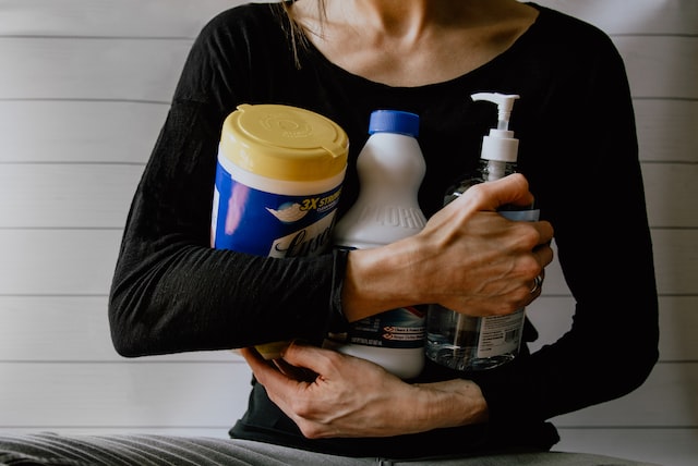 woman gathering cleaning supplies