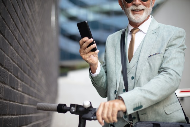 senior business man with electric scooter