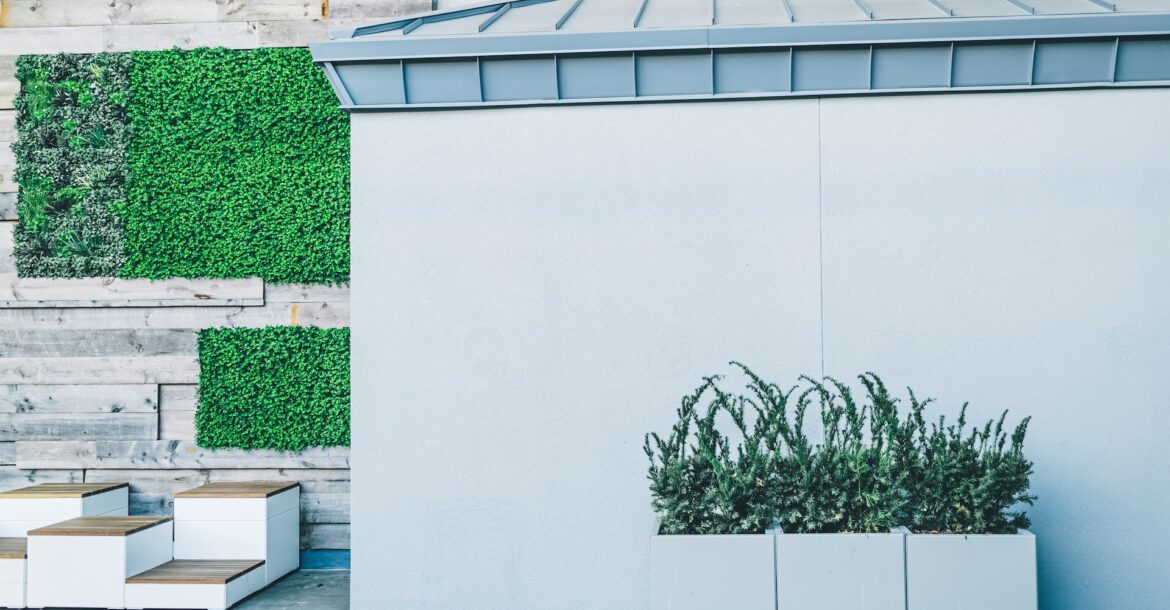 a white building with a planter on the side of it