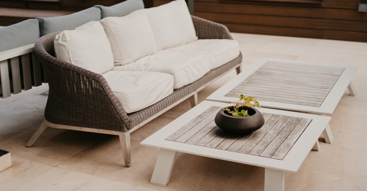 outdoor living room with a couch and a coffee table