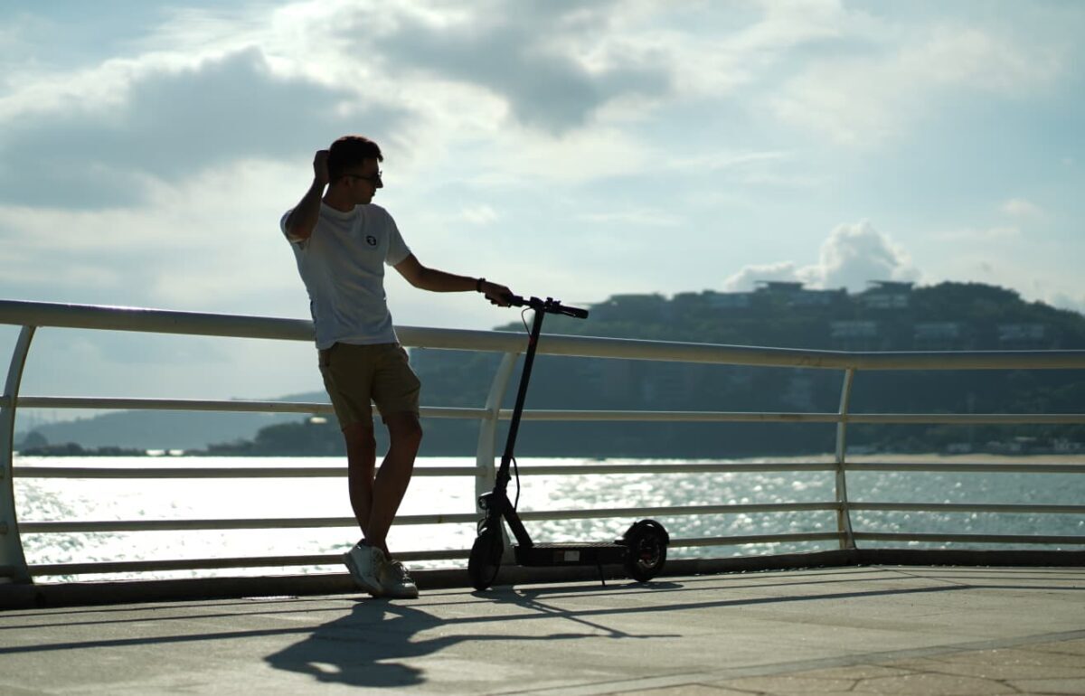 person speaking by the phone holding scooter