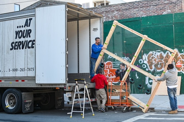 persons moving somebody house on truck