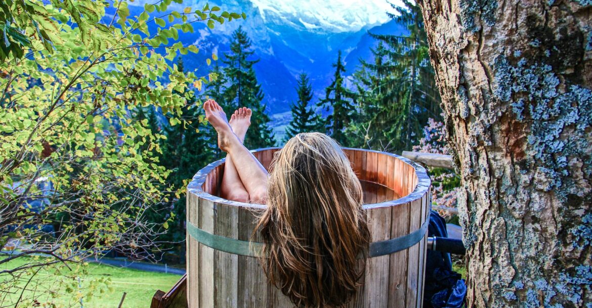 person in wooden hot tub