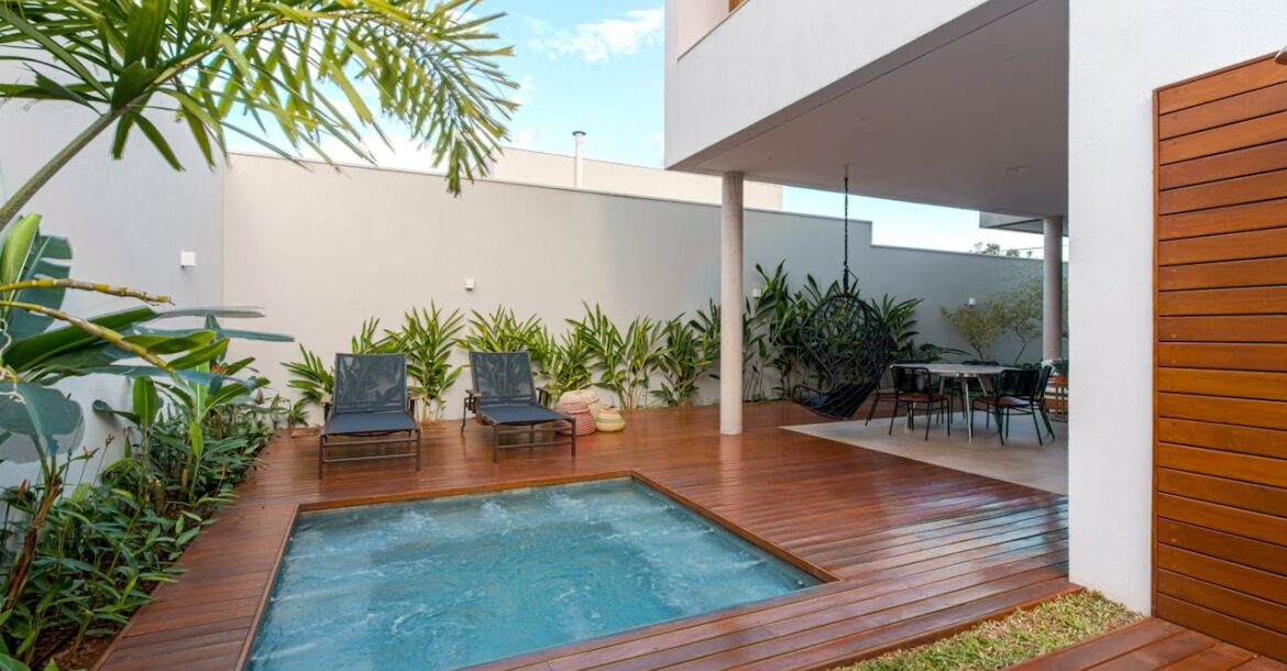 a-pair-of-black-lounge-chairs-near-jacuzzi