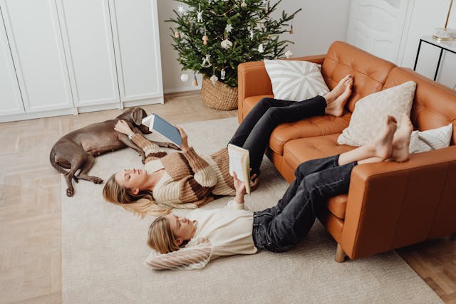 woman-and-teenager-relaxing-with-books-at-christmas-time