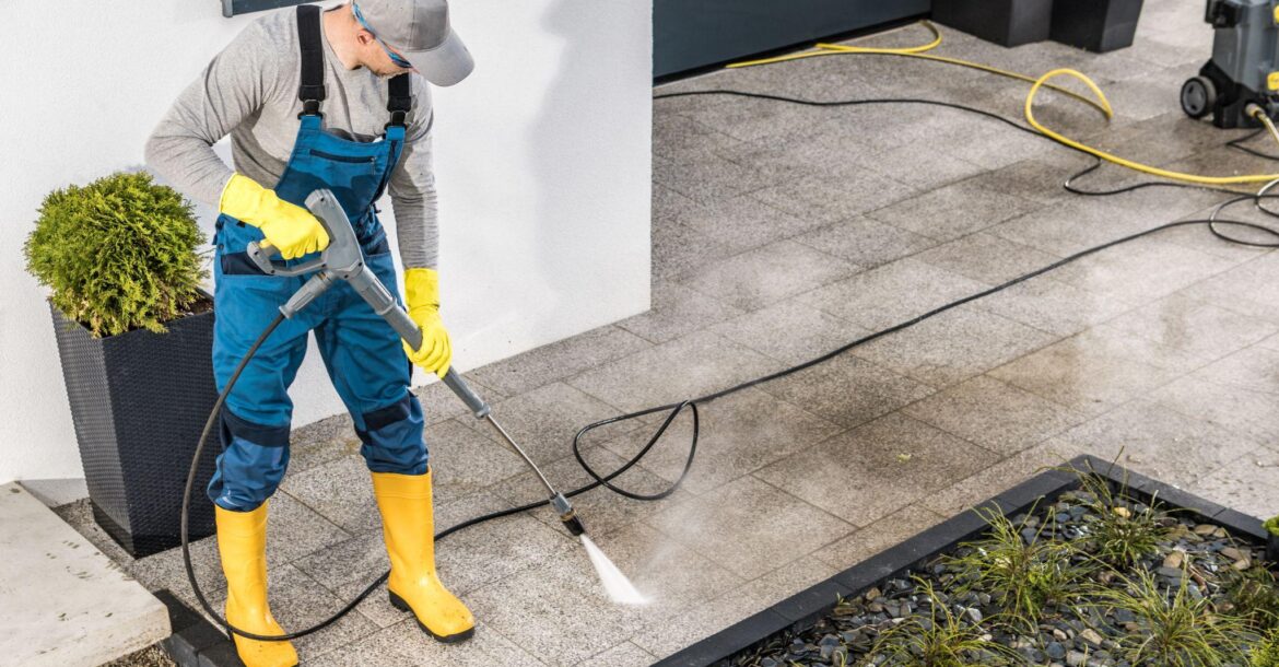 men-pressure-washing-his-house-surrounding