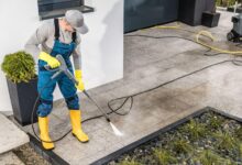 men-pressure-washing-his-house-surrounding