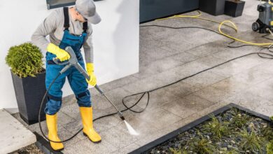 men-pressure-washing-his-house-surrounding