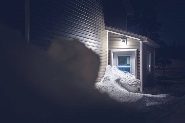 white-snow-covered-ground-near-white-wooden-house