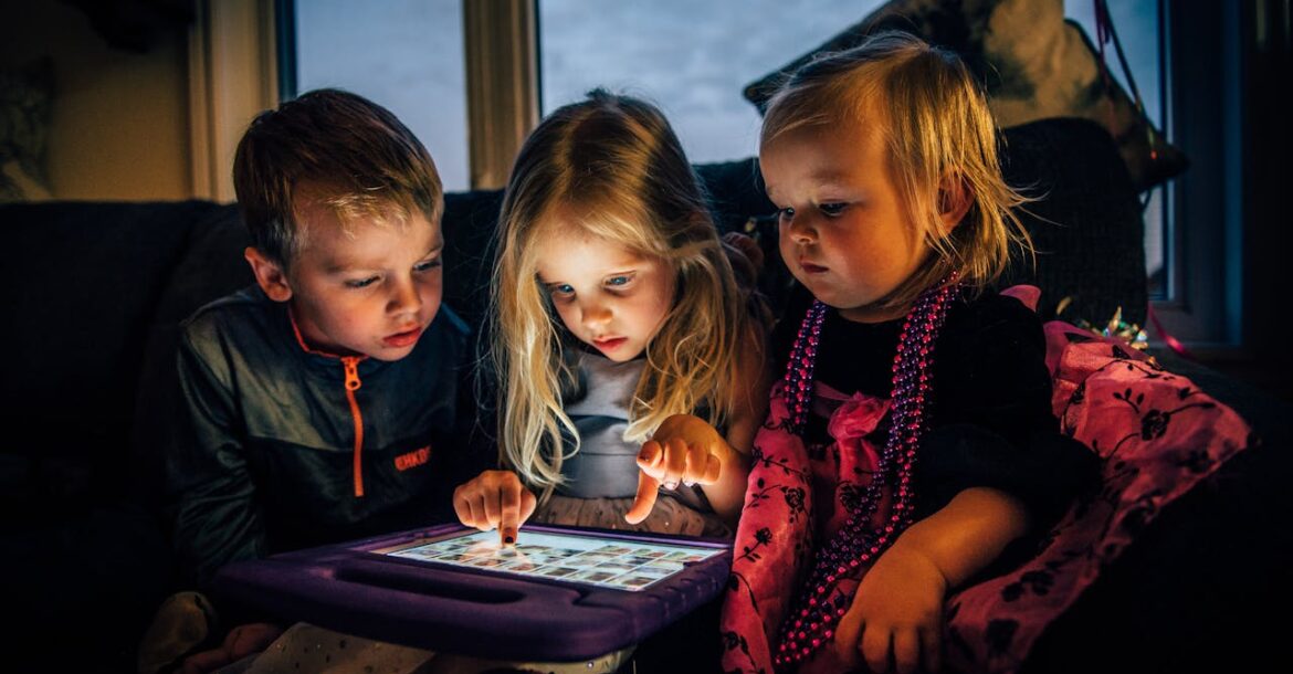 three-children-looking-at-a-tablet-computer
