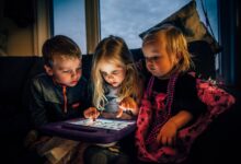 three-children-looking-at-a-tablet-computer