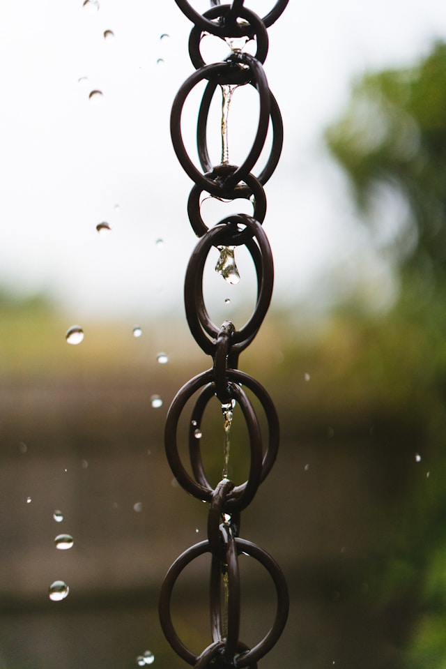 a-chain-hanging-from-the-side-of-a-window